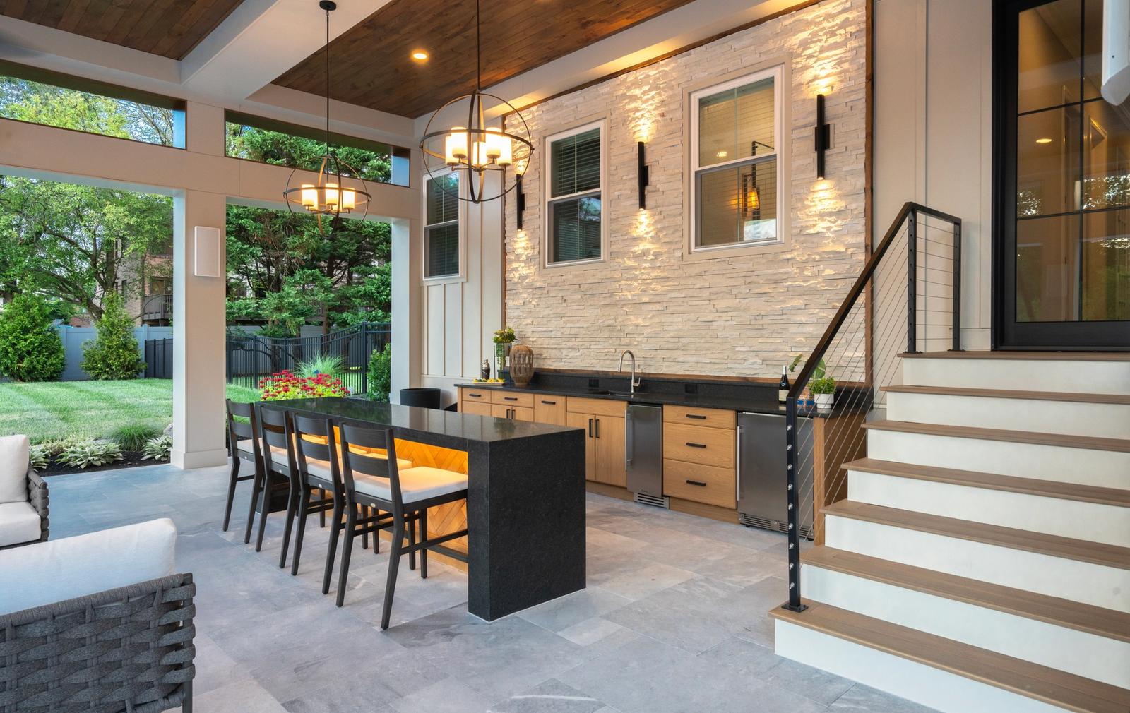 covered outdoor kitchen with large island under pergola