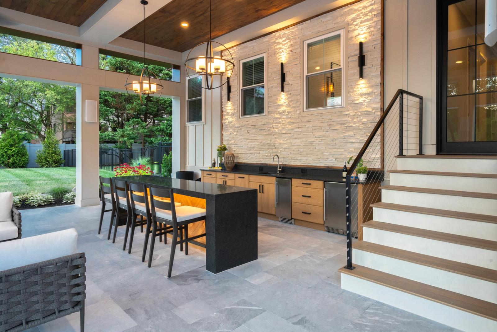 covered outdoor kitchen with large island under pergola