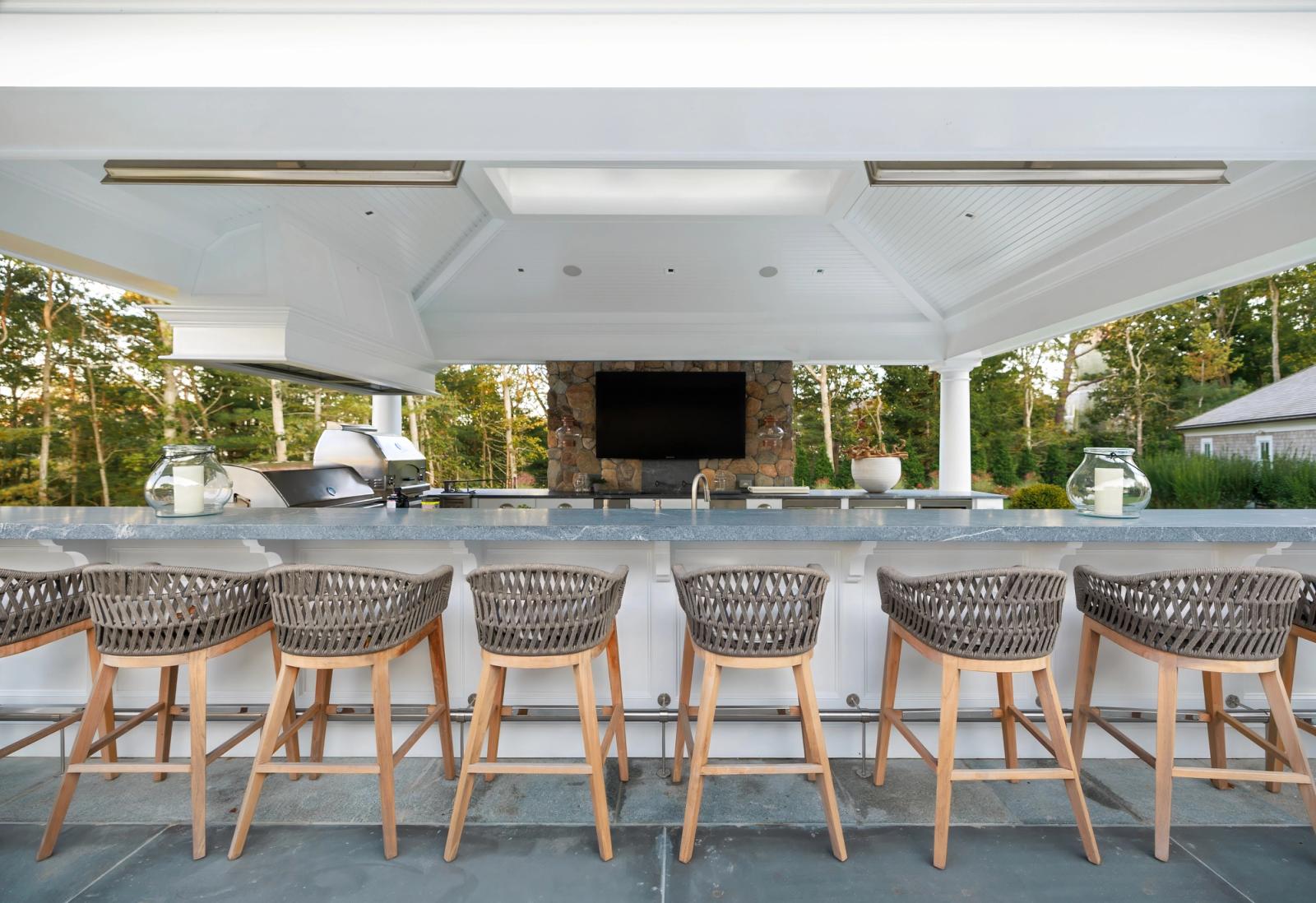 expansive outdoor seating bar under outdoor kitchen pavillion