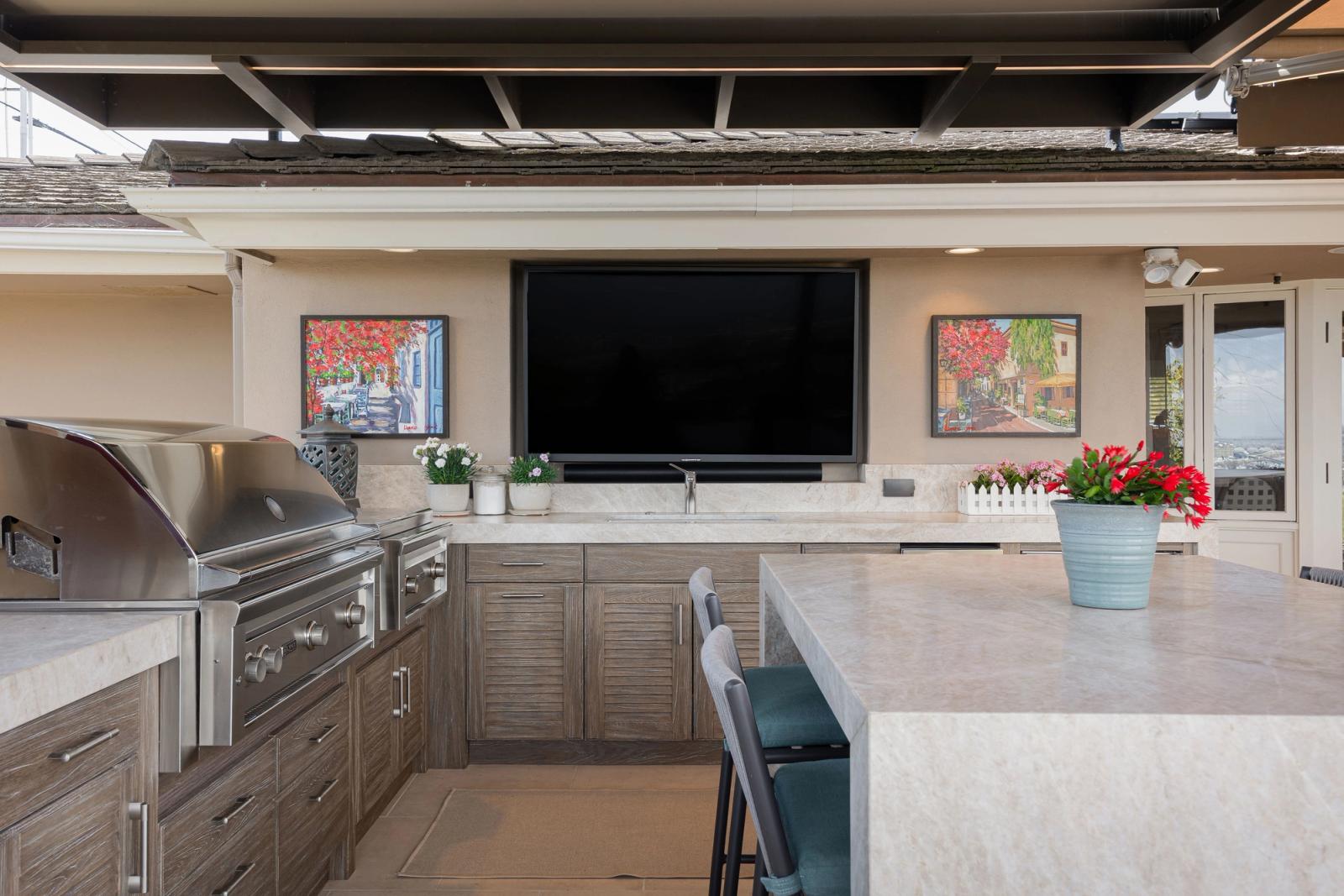 Covered patio kitchen with louvered driftwood cabinetry in california