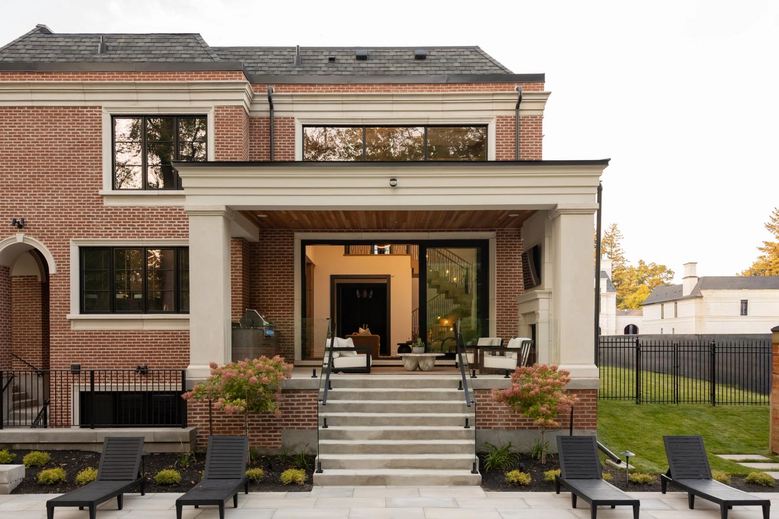 Brick Georgian home with a covered rear porch and naturekast outdoor kitchen