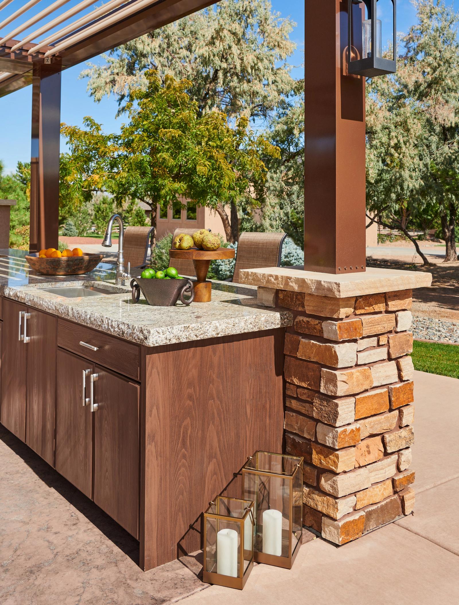Pergola kitchen in cypress kast cabinetry with a sink and granite counter
