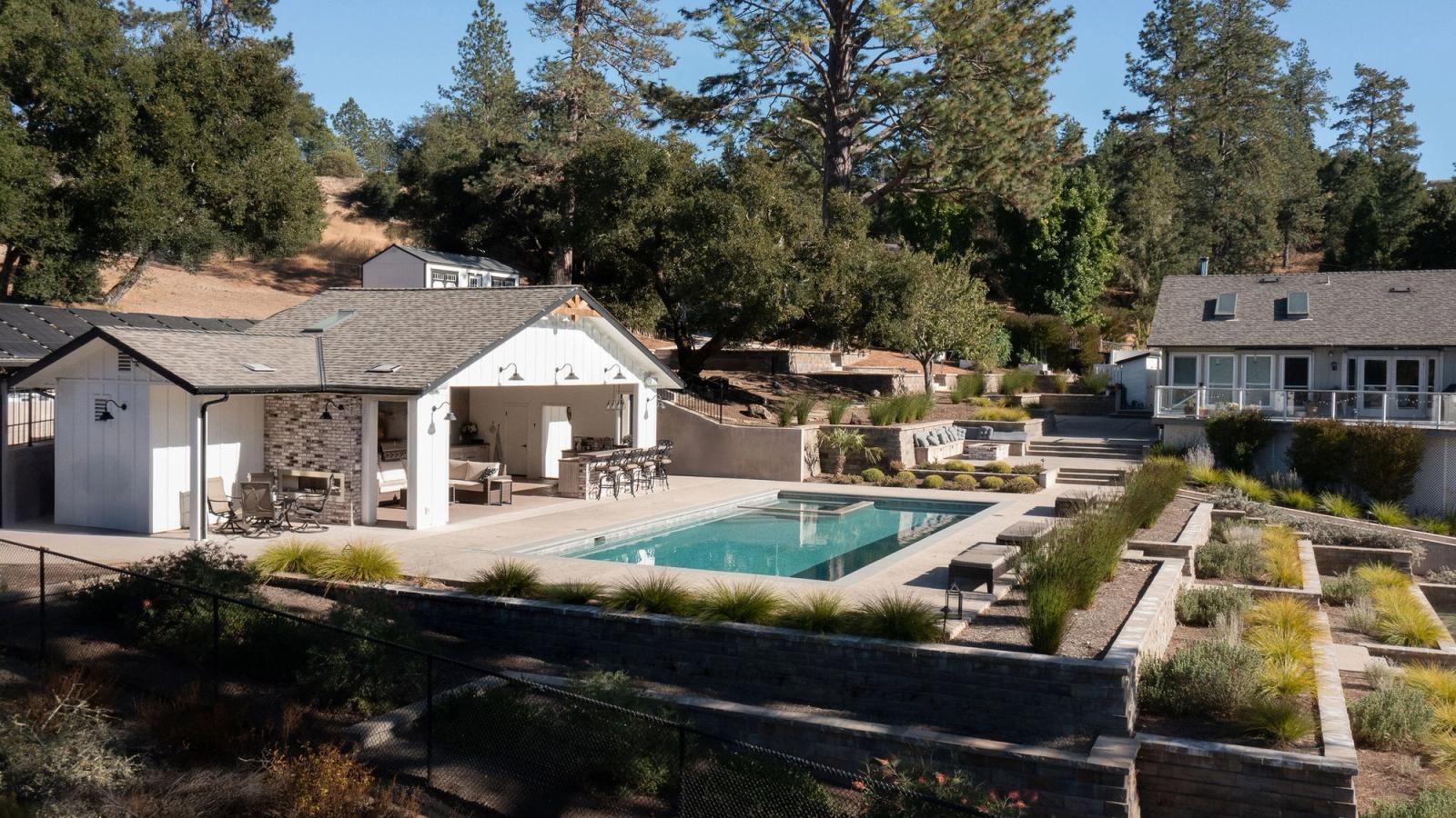 pool house near swimming pool with outdoor bar in california