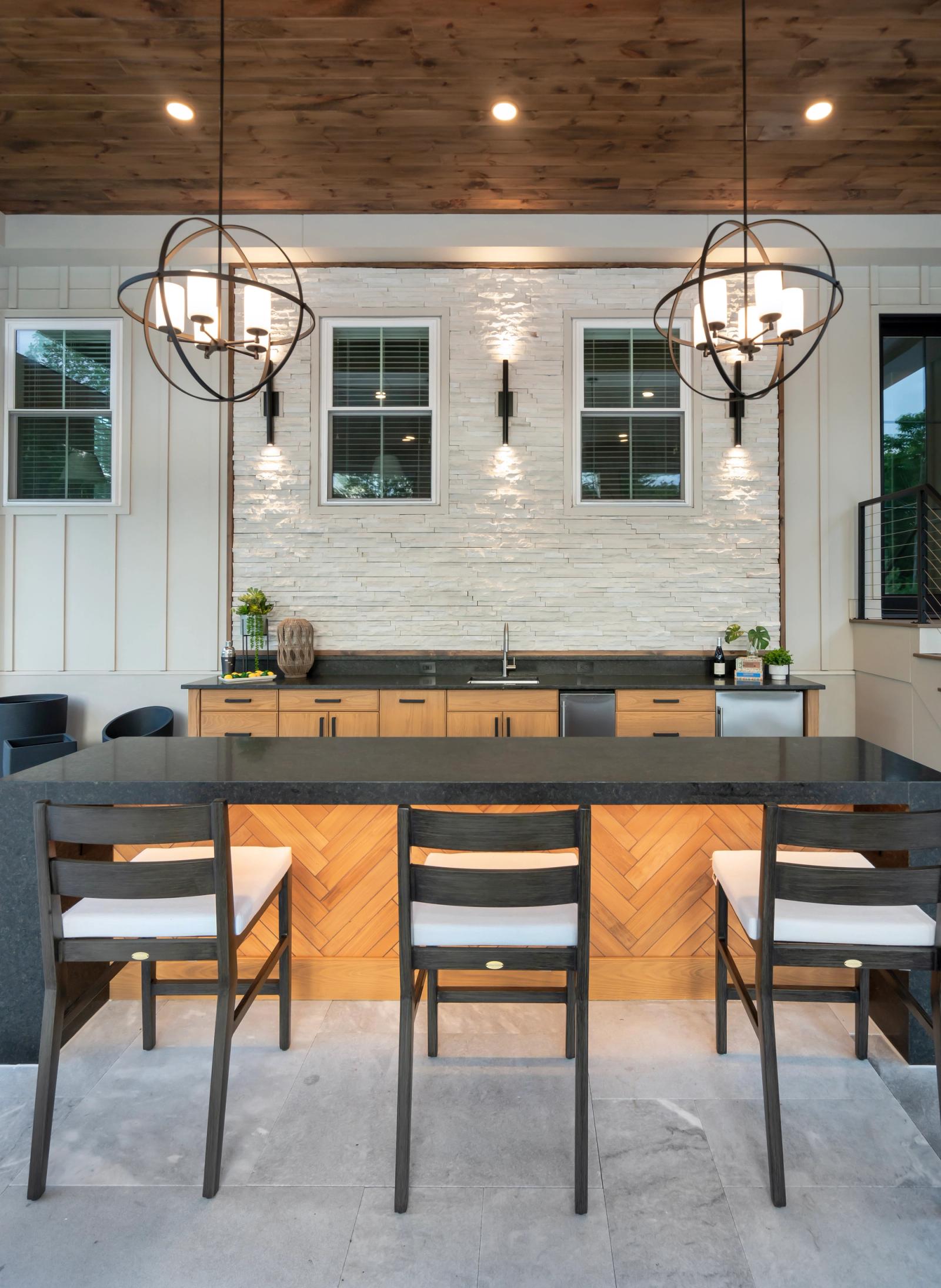 covered bar patio with light oak cabinets and dark counters