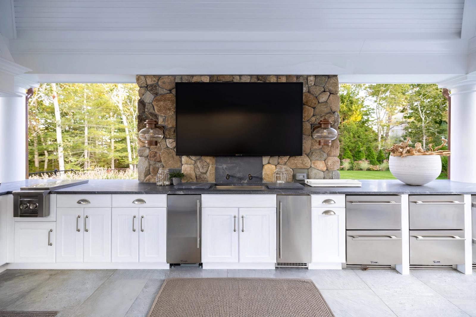 white shaker outdoor kitchen with storage and integrated appliances