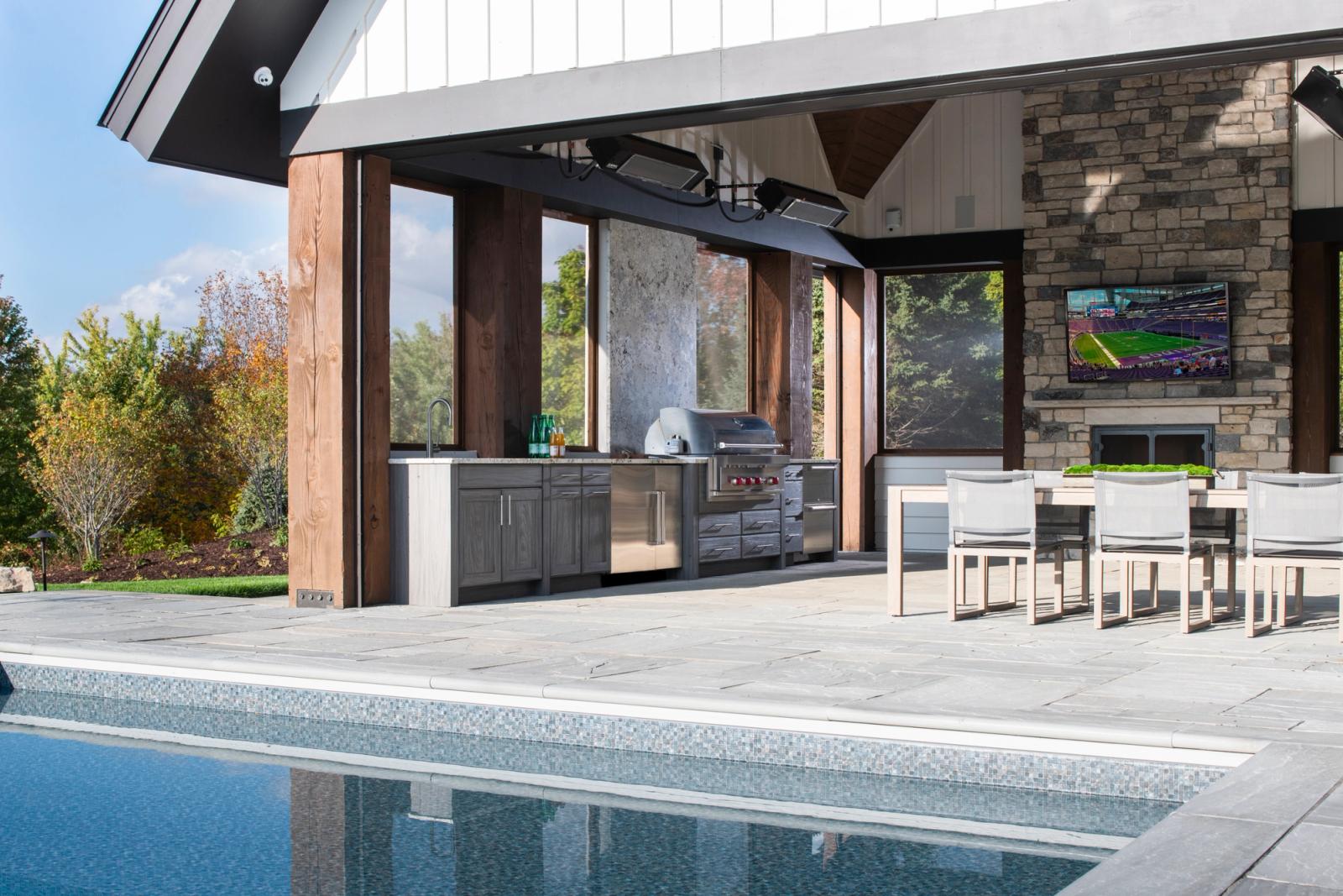 poolside outdoor kitchen under covered pavillion in long lake ontario