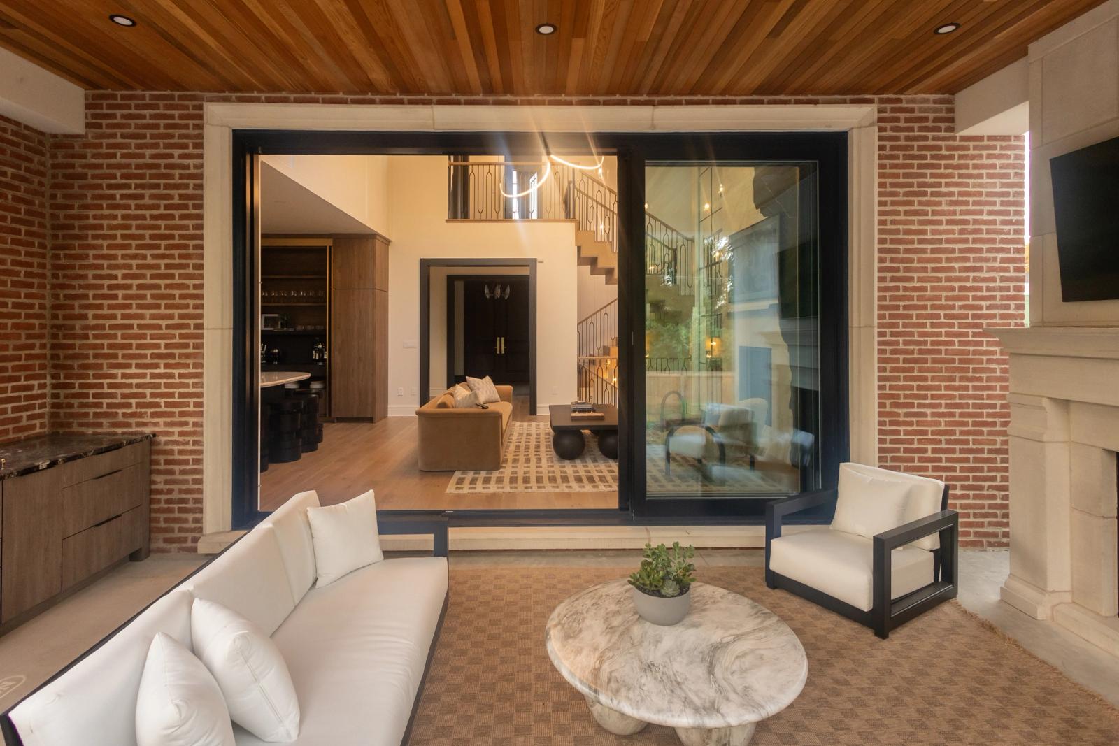 brick loggia with lounge seating surrounding outdoor kitchen in oakville