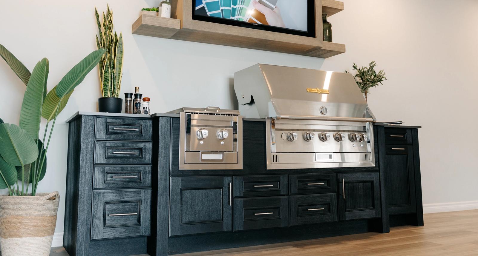 outdoor kitchen showroom display with grill cabinet and TV