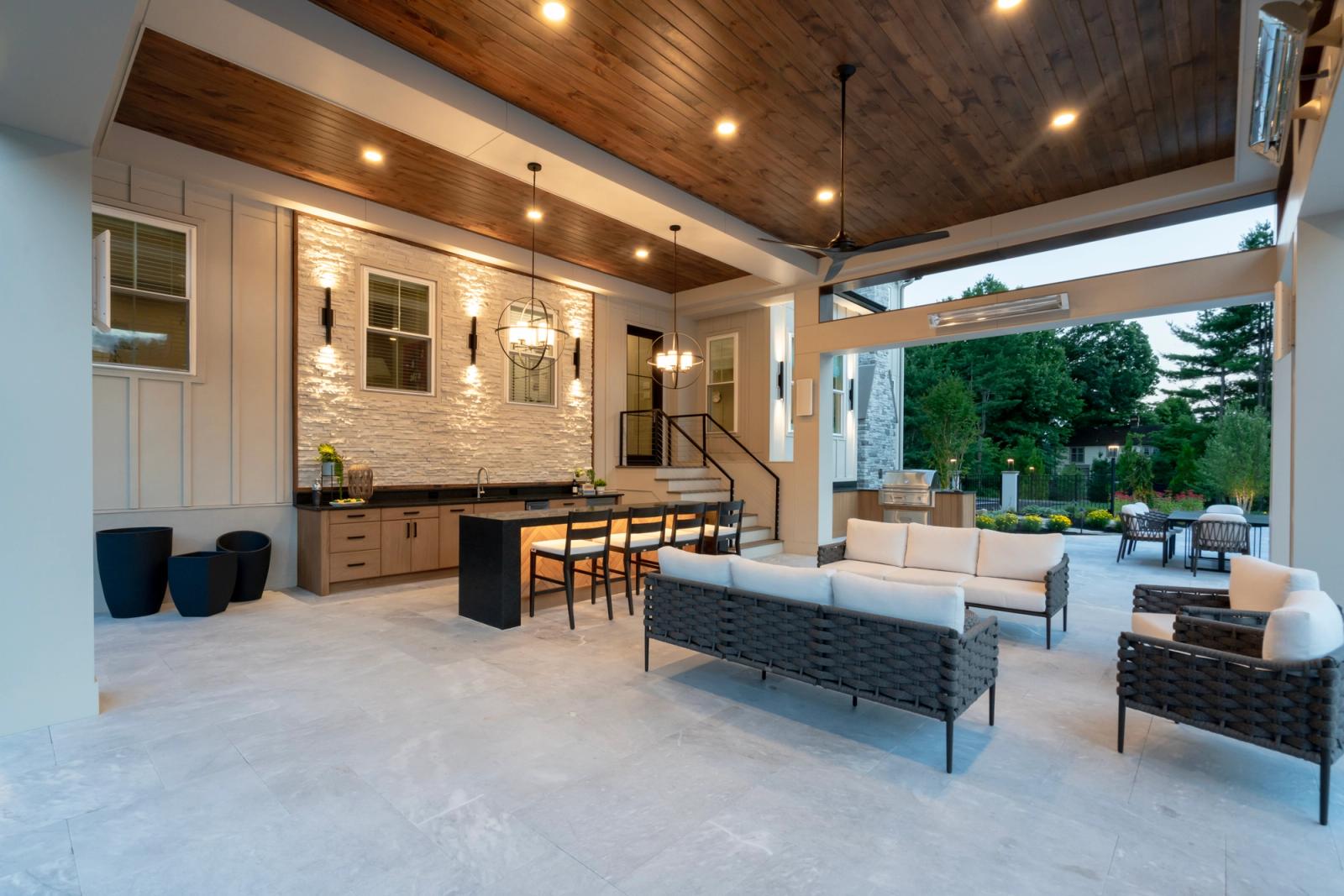 covered patio lounge and bar at dusk near sofa lounge chairs