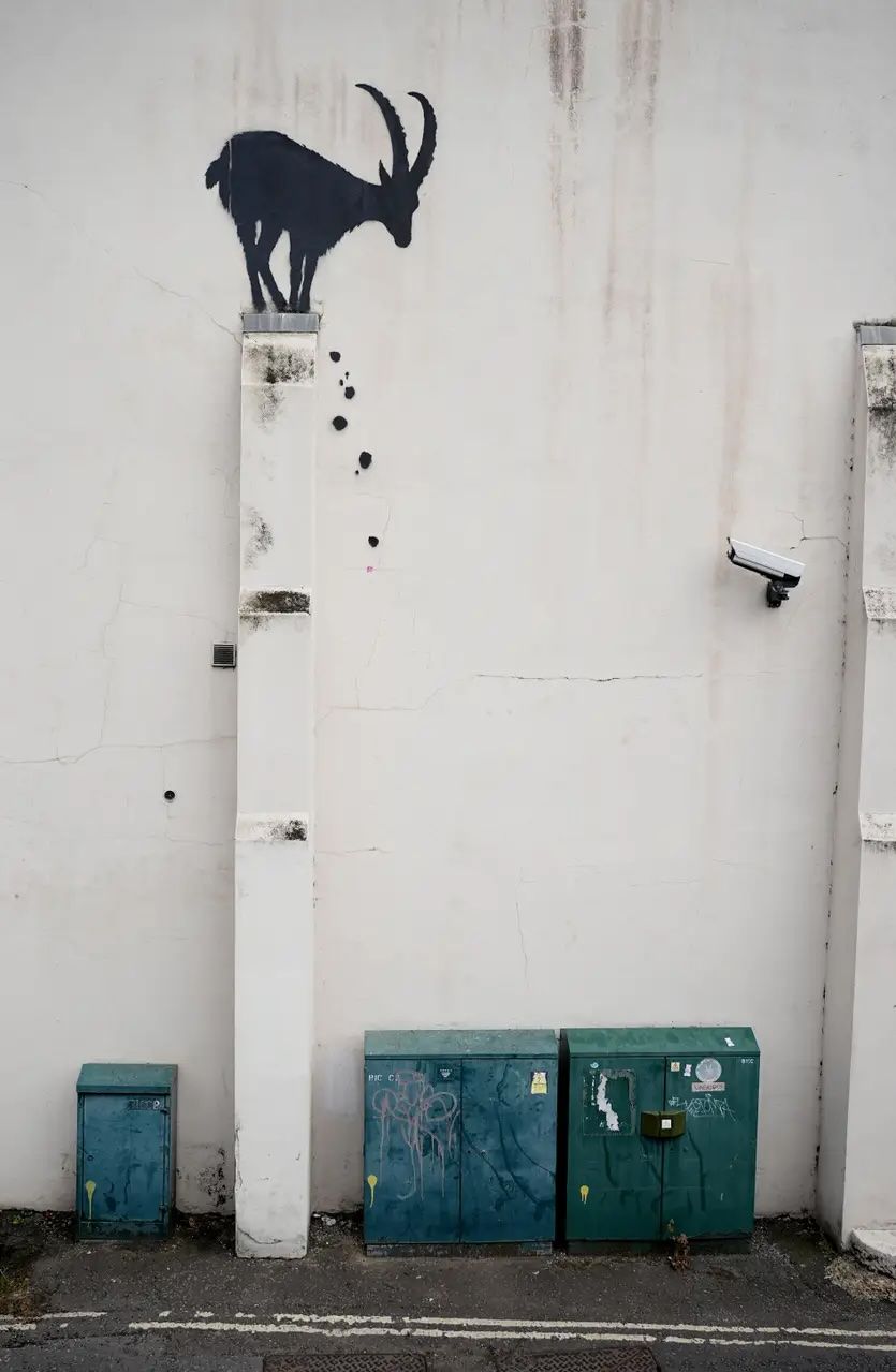 Banksy’s goat perched above a CCTV camera near Kew Bridg