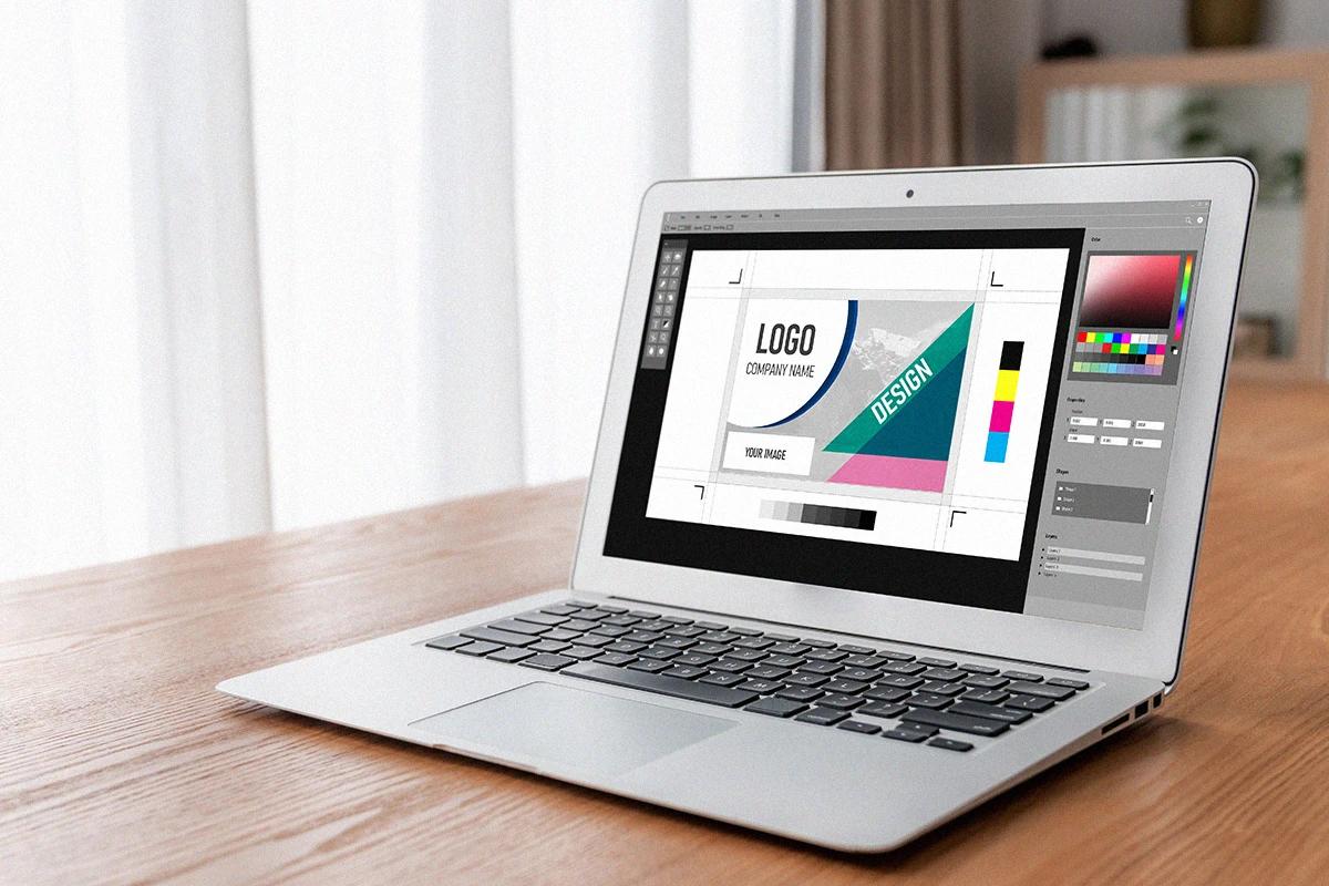 A laptop on a table with a design program open