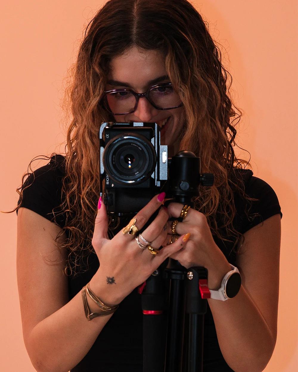 Young woman using a professional camera for social media