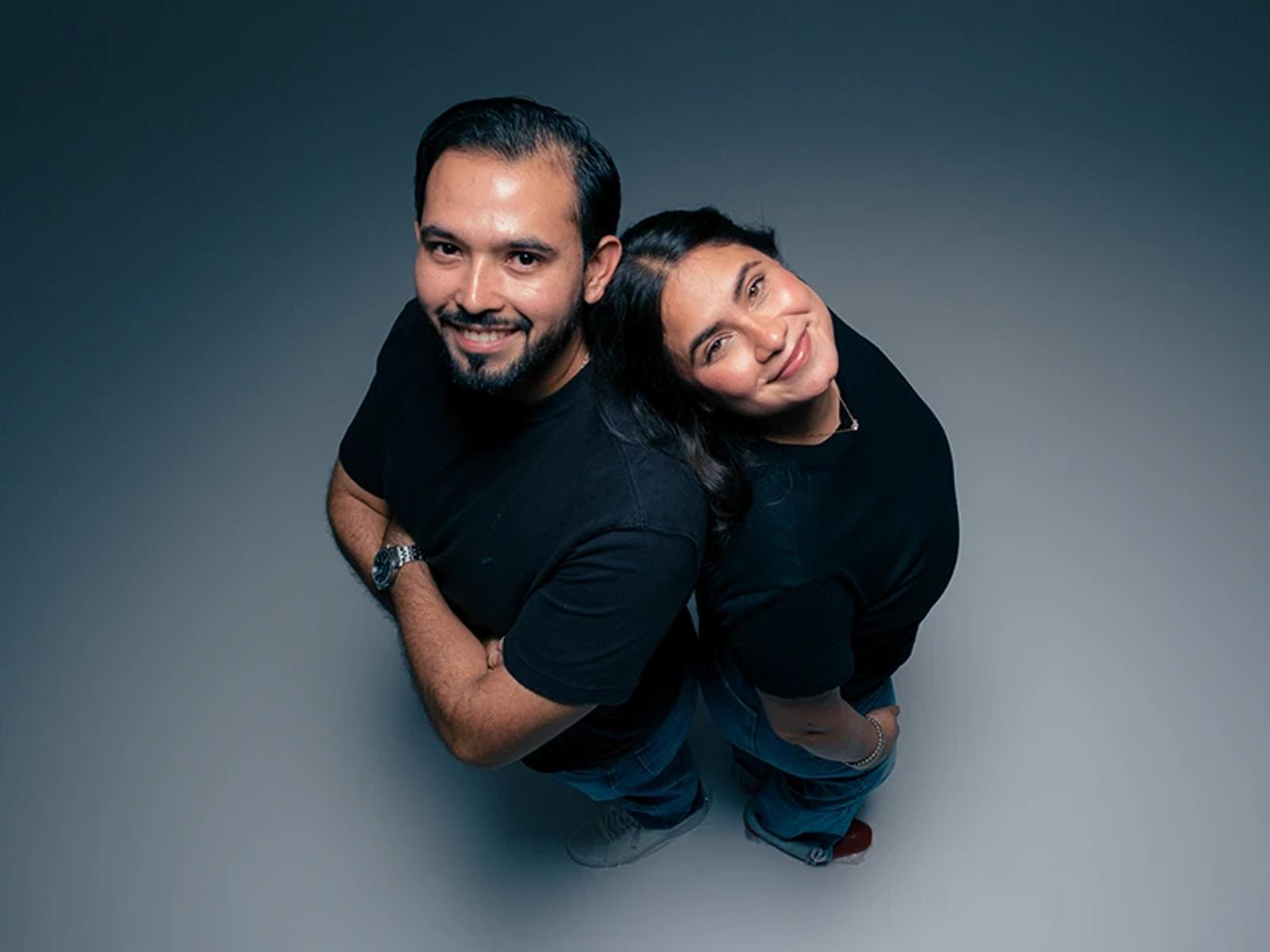 Two Hiweb team members posing back to back during a photo shoot