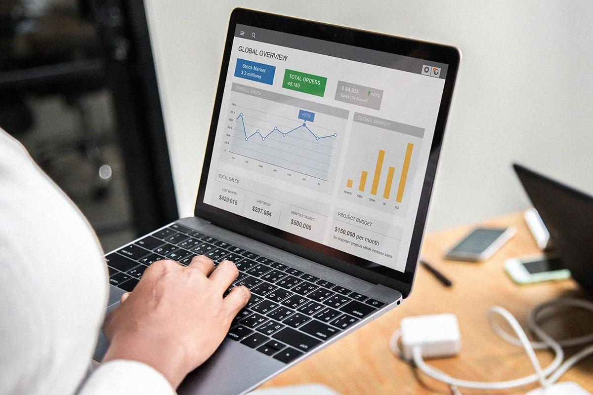 Person typing on a laptop, managing Google Ads charts and metrics