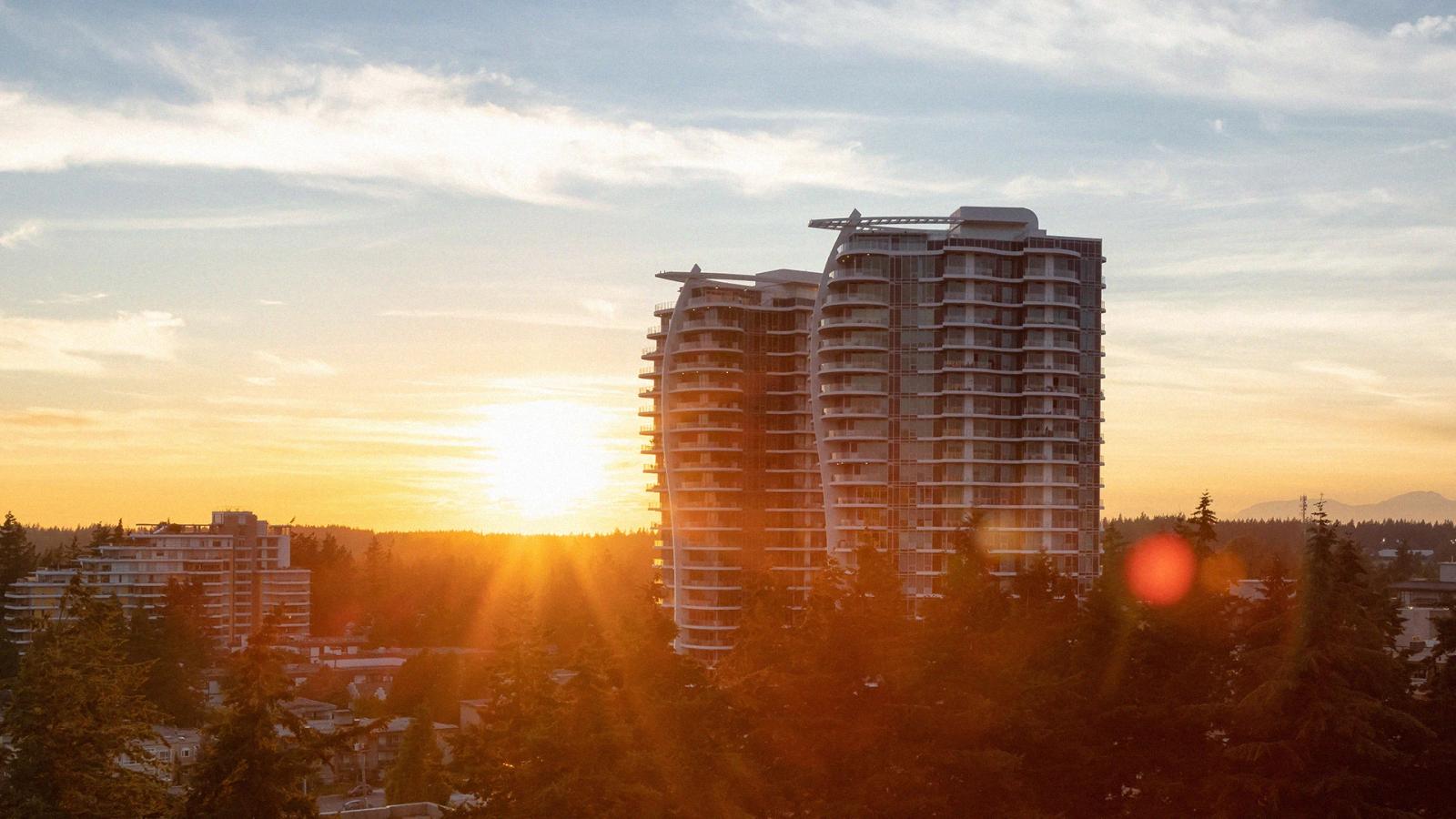 Modern residential buildings at sunset representing real estate developments, urban architecture, and growth opportunities in the real estate industry Hiweb.