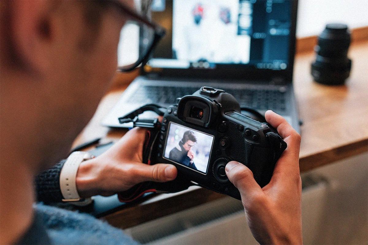 Editor or photographer reviewing photographs on their professional camera