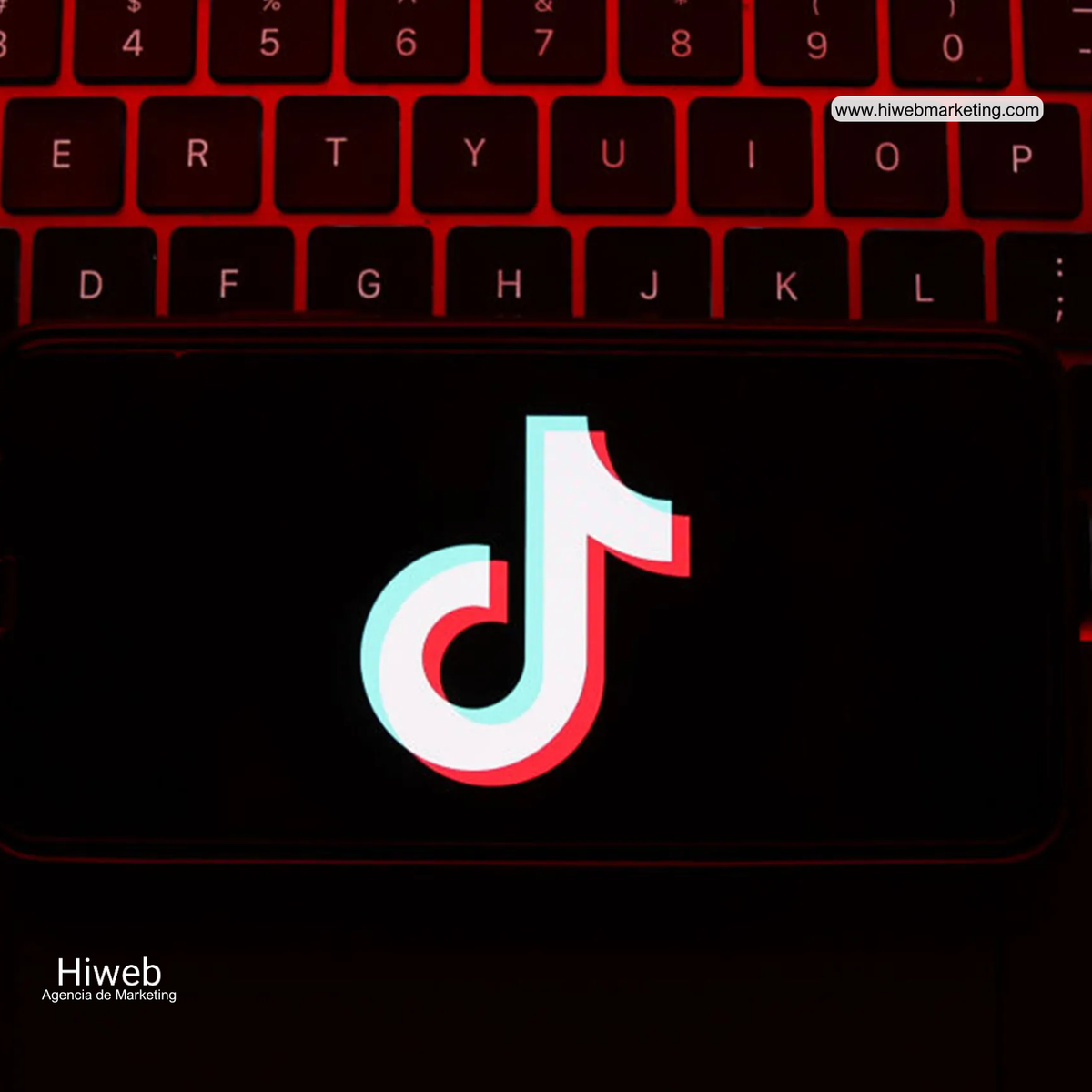 TikTok logo on a computer keyboard screen with red lighting, representing social media, digital content, and video platforms within digital marketing, Hiweb.