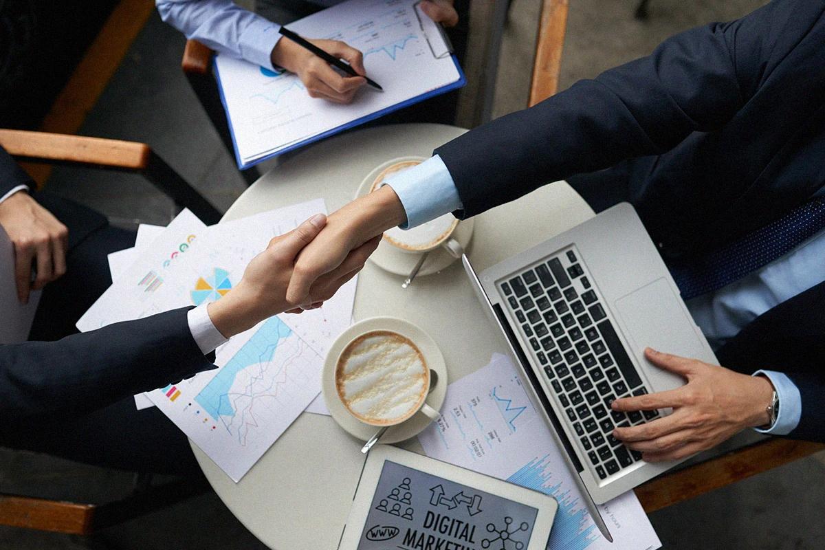 Executive team holding a business meeting with documents and technology to develop result-driven digital strategies Hiweb.