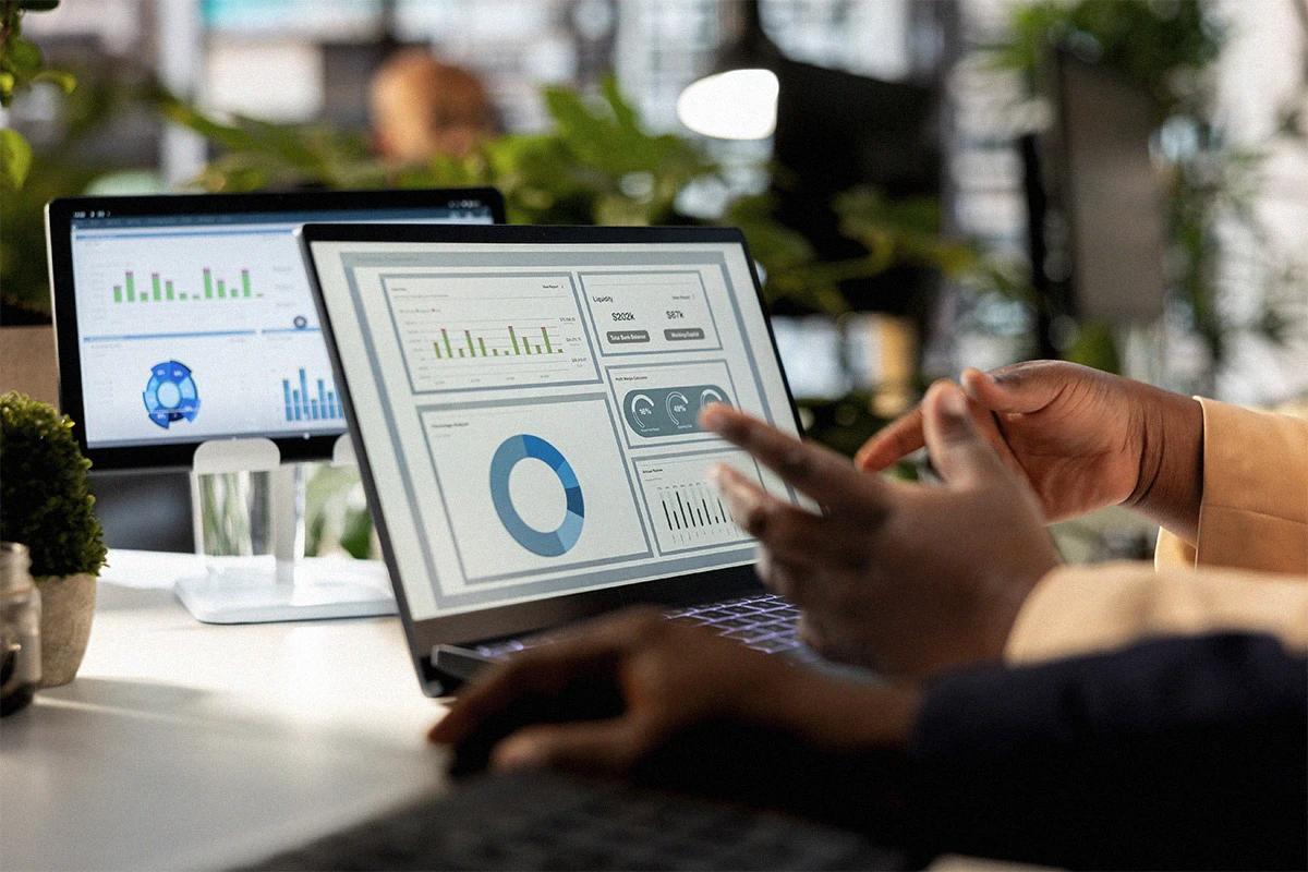 Team analyzing digital metrics and reports on screens to optimize marketing strategies, automation, and business growth through data Hiweb.