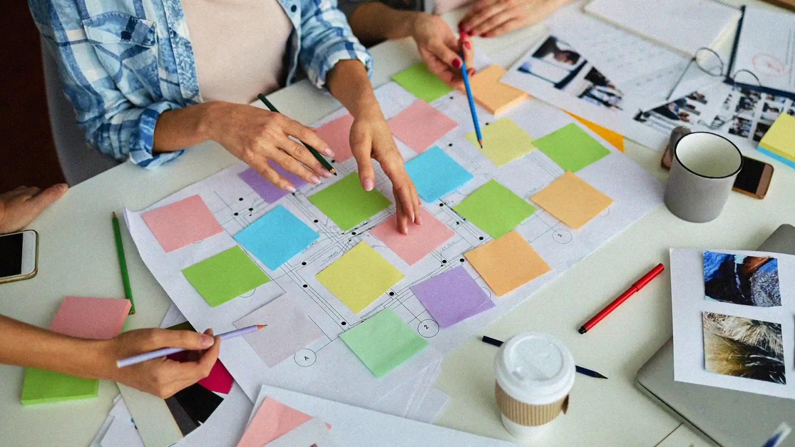 Creative meeting with planners and sticky notes on a desk