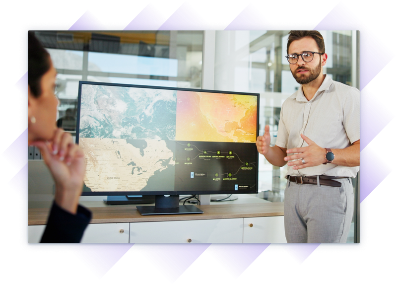 Man in business casual attire has come to an office building to show various GIS mapping layers to a professional team.