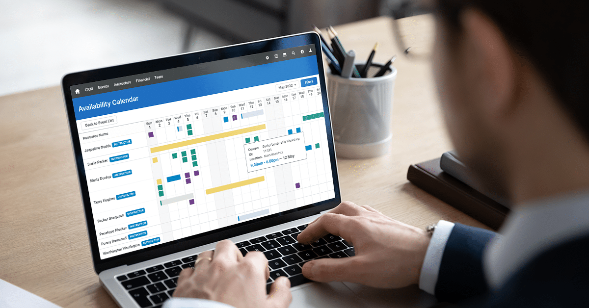 Training professional looking at the Availability Calendar feature of Administrate on their laptop.