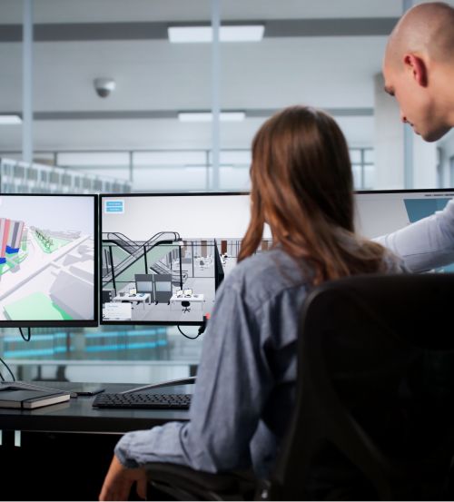 Man gestures at computer monitor while learner is watching during a instructor-led training session.