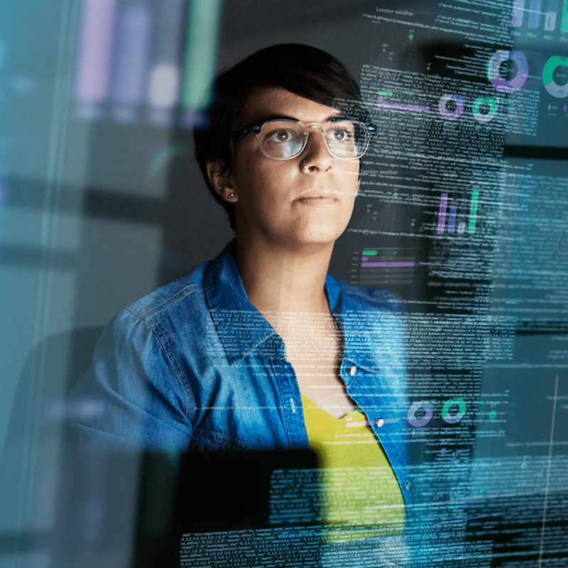 Person in glasses and denim shirt looking upward, overlaid with digital code, analytics charts, and data visualization elements.