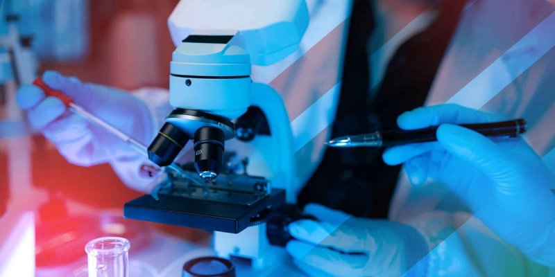 Close-up of scientists wearing gloves using lab equipment, including a microscope and pipette, in a training session.