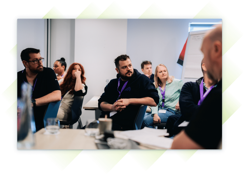 A team member listening in a conference room at the Customer Summit.