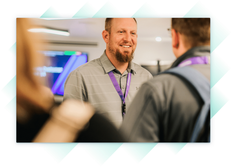 Administrate employee speaking with customer at our Customer Summit.