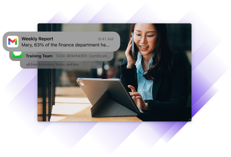 A training administrator smiles while viewing a tablet and receiving automated alerts about training progress and reminders.