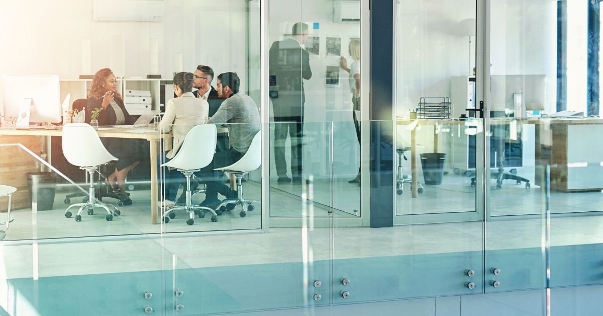 Group of training professionals in an office setting at a table.