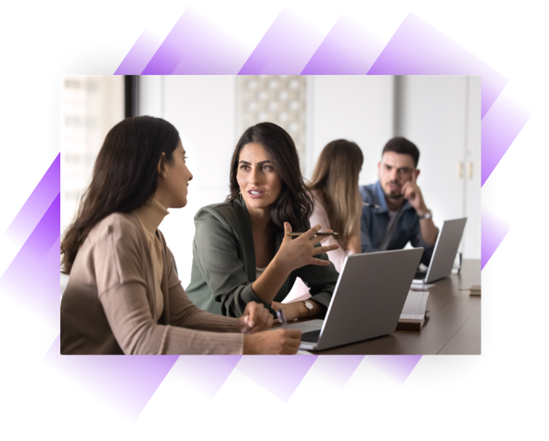Woman accountant explaining something to an apprentice in an office setting.