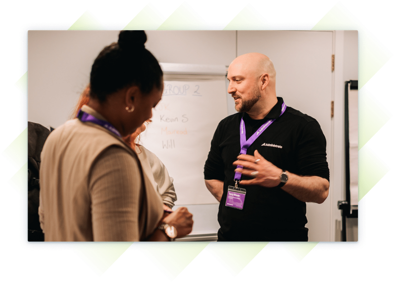 Administrate employee having a discussion with customers at our Customer Summit.