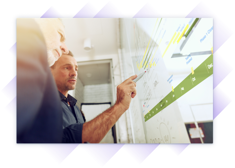 Two men reviewing and discussing a project timeline.