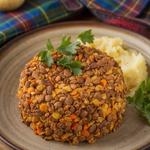 Plate of vegetarian haggis garnished with fresh parsley.