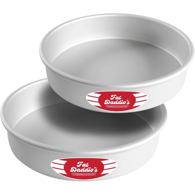 Two silver anodized aluminum round cake pans stacked at an angle