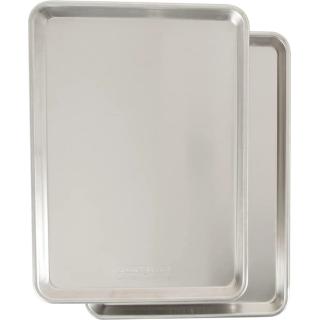 Two natural aluminum rimmed baking sheets stacked at an angle