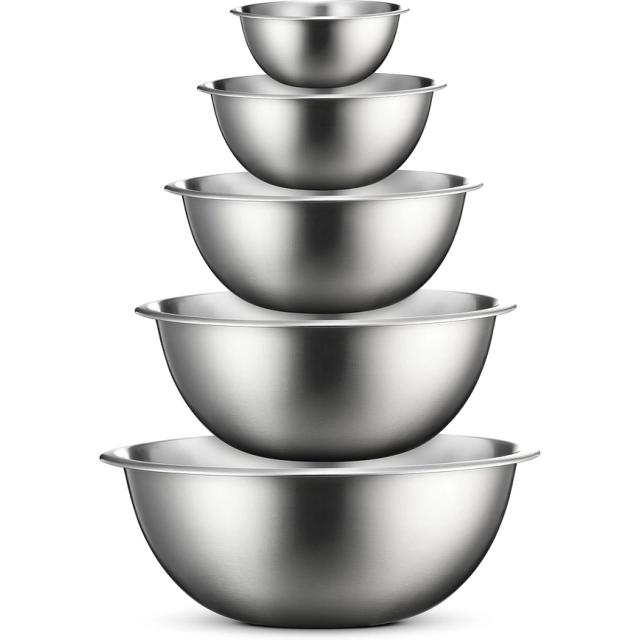 Five stainless steel mixing bowls nested in a stack from small to large