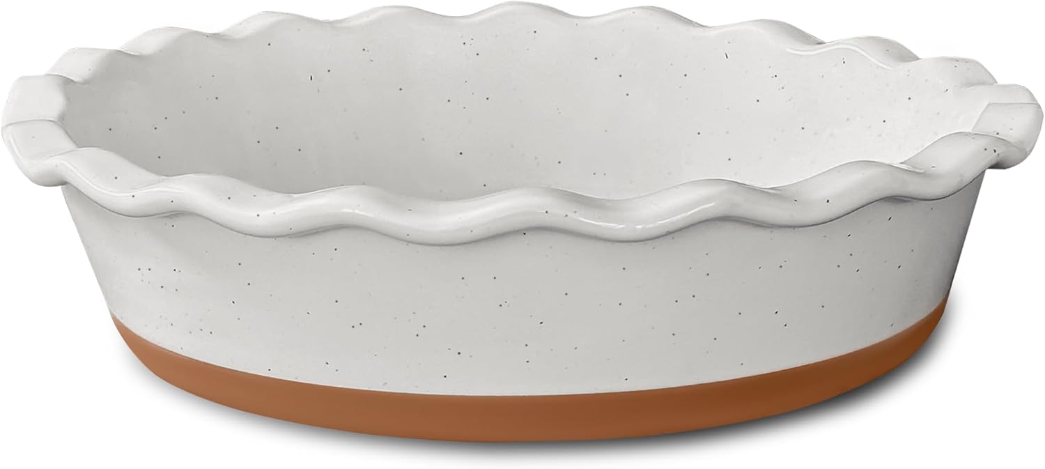 White speckled ceramic pie dish with a fluted rim and a terracotta base