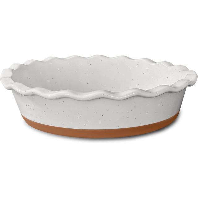 White speckled ceramic pie dish with a fluted rim and a terracotta base