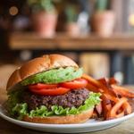 Black bean veggie burger with fresh toppings on a toasted bun.