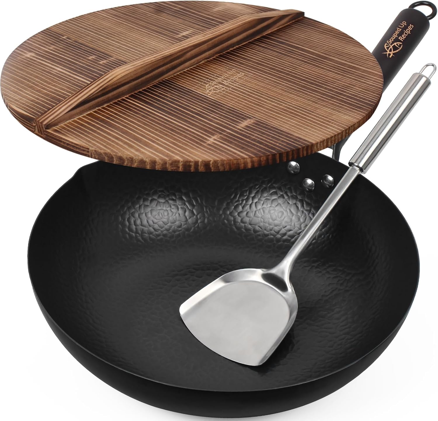 Black hammered carbon steel flat-bottom wok with a steel handle, shown with a wooden lid and a stainless steel spatula