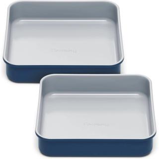 Two navy blue square baking pans with pale ceramic non-stick interiors