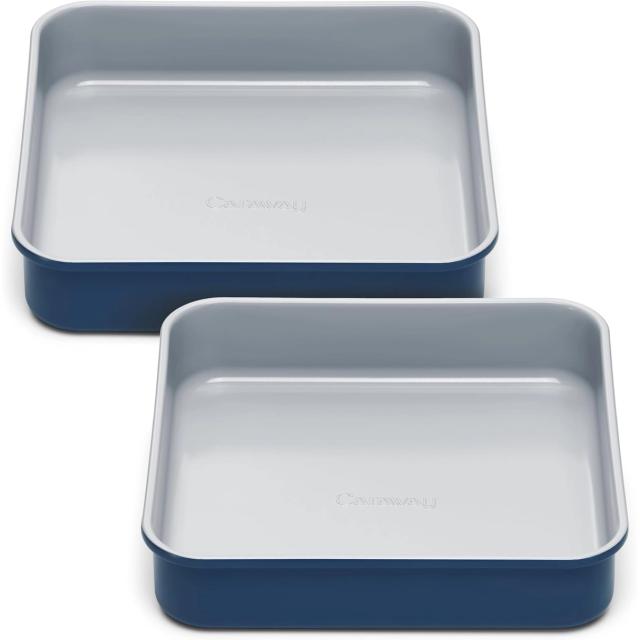 Two navy blue square baking pans with pale ceramic non-stick interiors