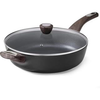 Deep black non-stick skillet with a glass lid and wood-effect handles
