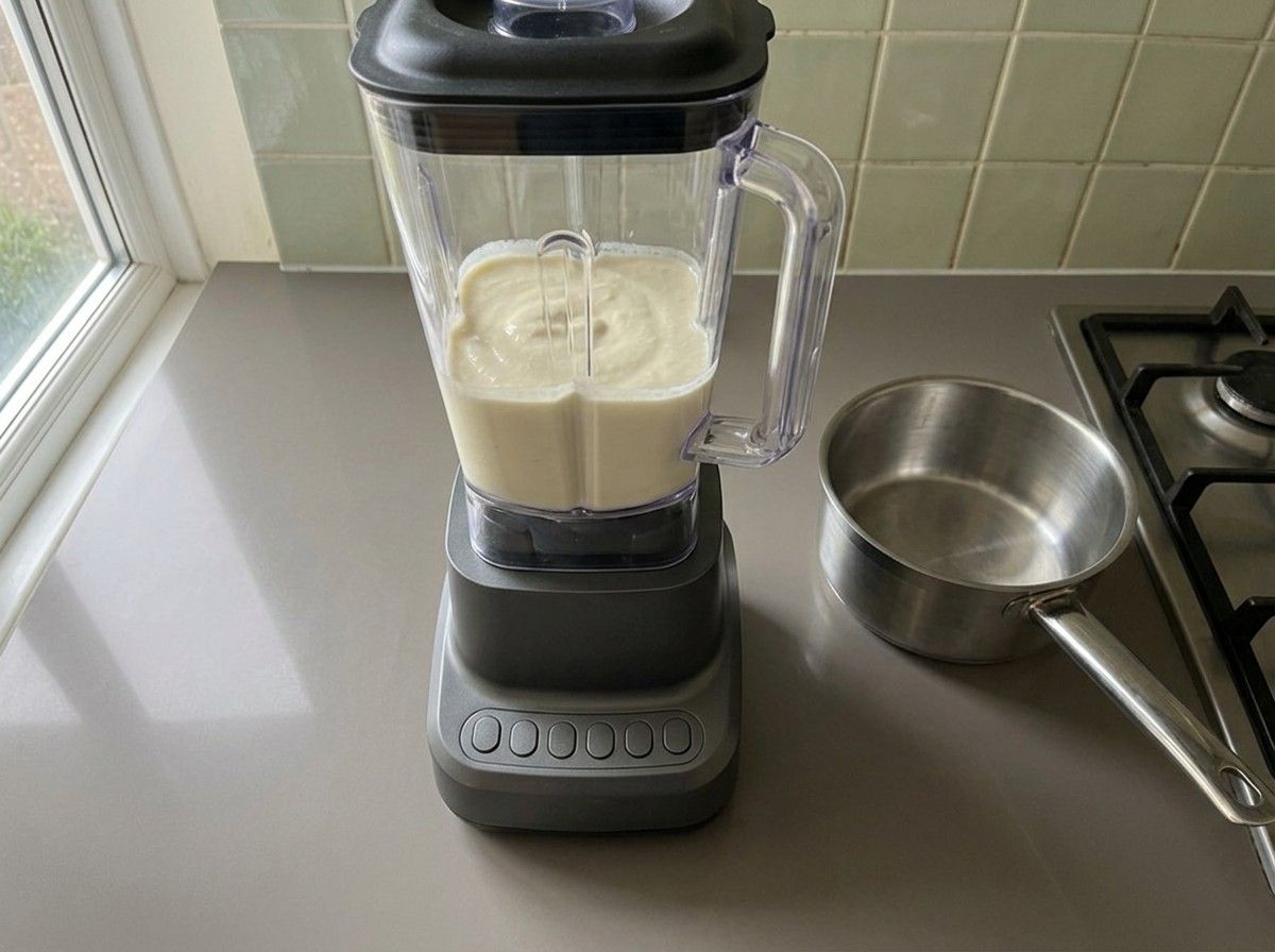 The boiled onion and cashews blended into a smooth pale ivory paste in a blender