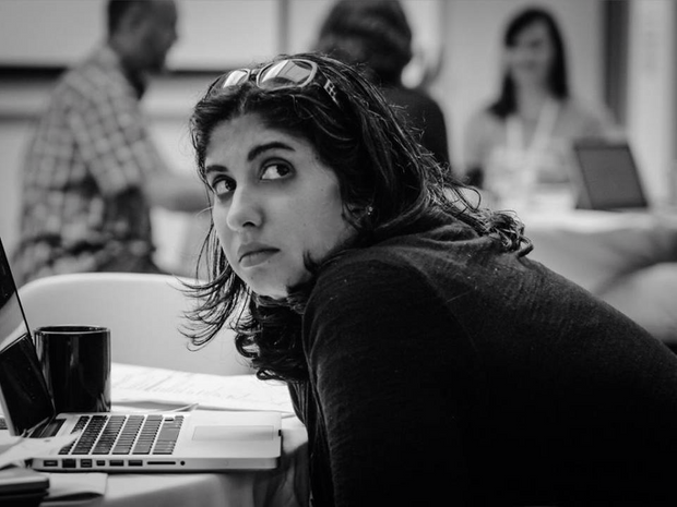 Roopika Risam looking up from her laptop