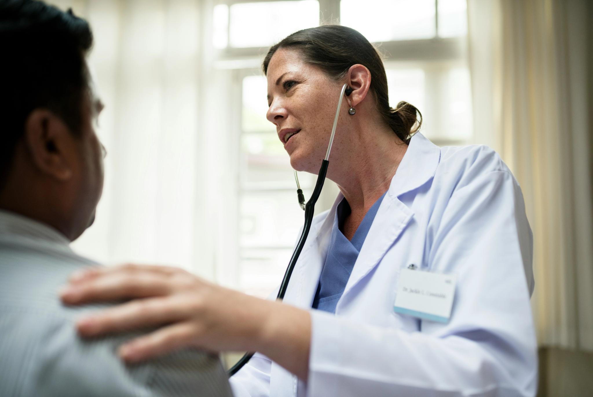 A doctor checks on a patient